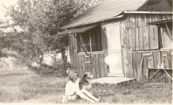 1945:  The Martin shack. Nancy and dog Teddy.