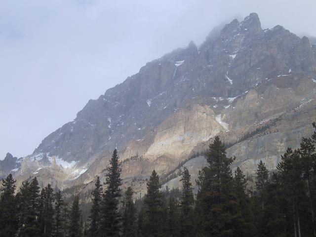 Band of light across craggy mountaintop, Icefields Parkway.