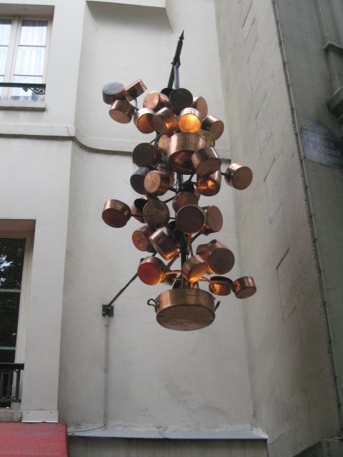 A copper-pot sculpture over a cafe, near Place Saint-Michel, Rive Gauche.