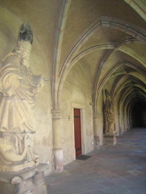 Arched stone ceilings over a path that goes around the courtyard.