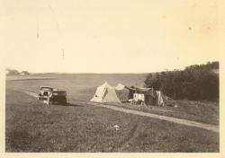 1933:  Camping with farm in background.