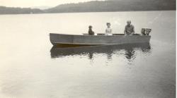 1945?:  Bob, Nancy, Wilbur in new boat he made in Freds Shed.