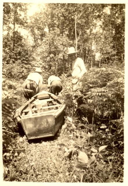 1940s:  Wilbur and others portaging canoe.