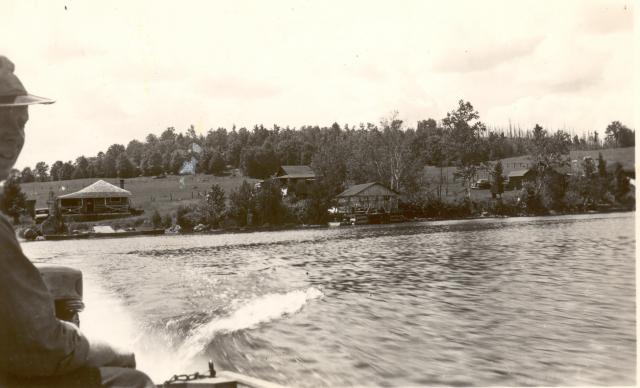 1945:  Dow in boat. Notice fire damage to woods in back.