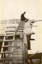 1947:  Building present-day Martin cabin. Wilbur on roof.